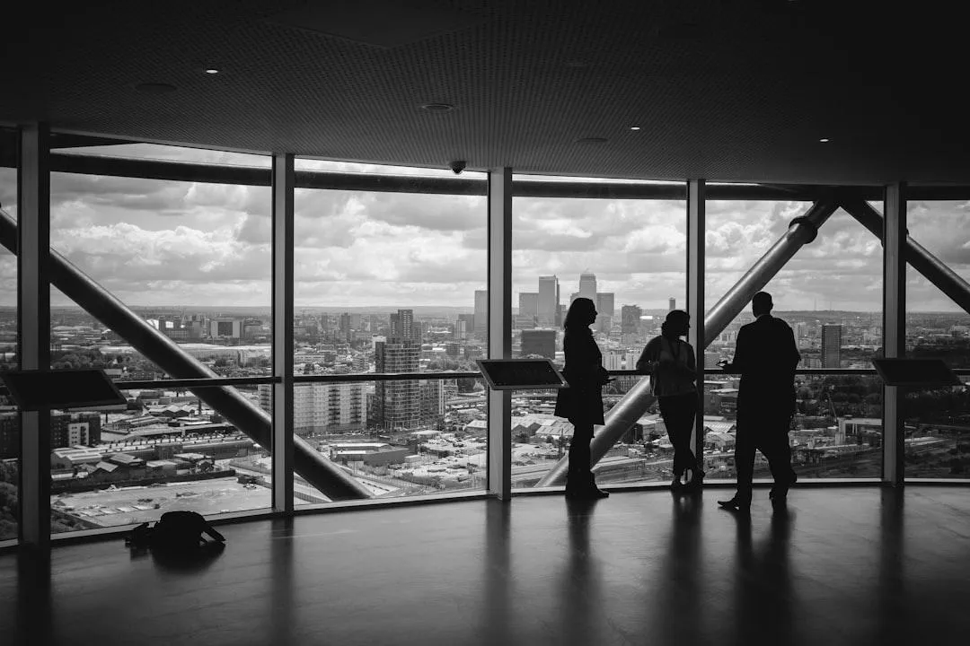 Business professionals in conversation on an observation deck overlooking a city skyline